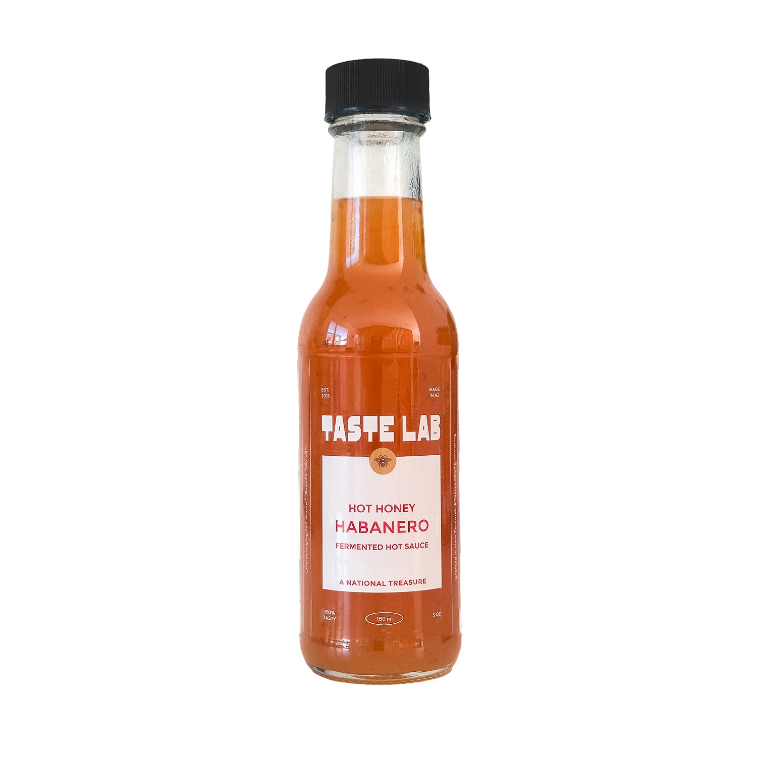 Bottle of Taste Lab Hot Honey Habanero fermented hot sauce on white.