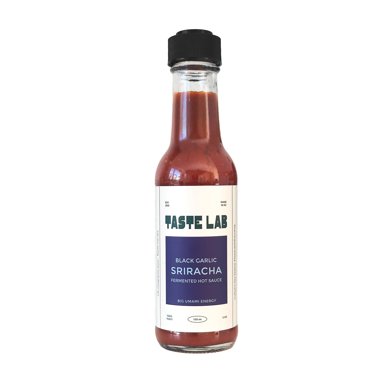 Bottle of Taste Lab Black Garlic Sriracha fermented hot sauce on white.