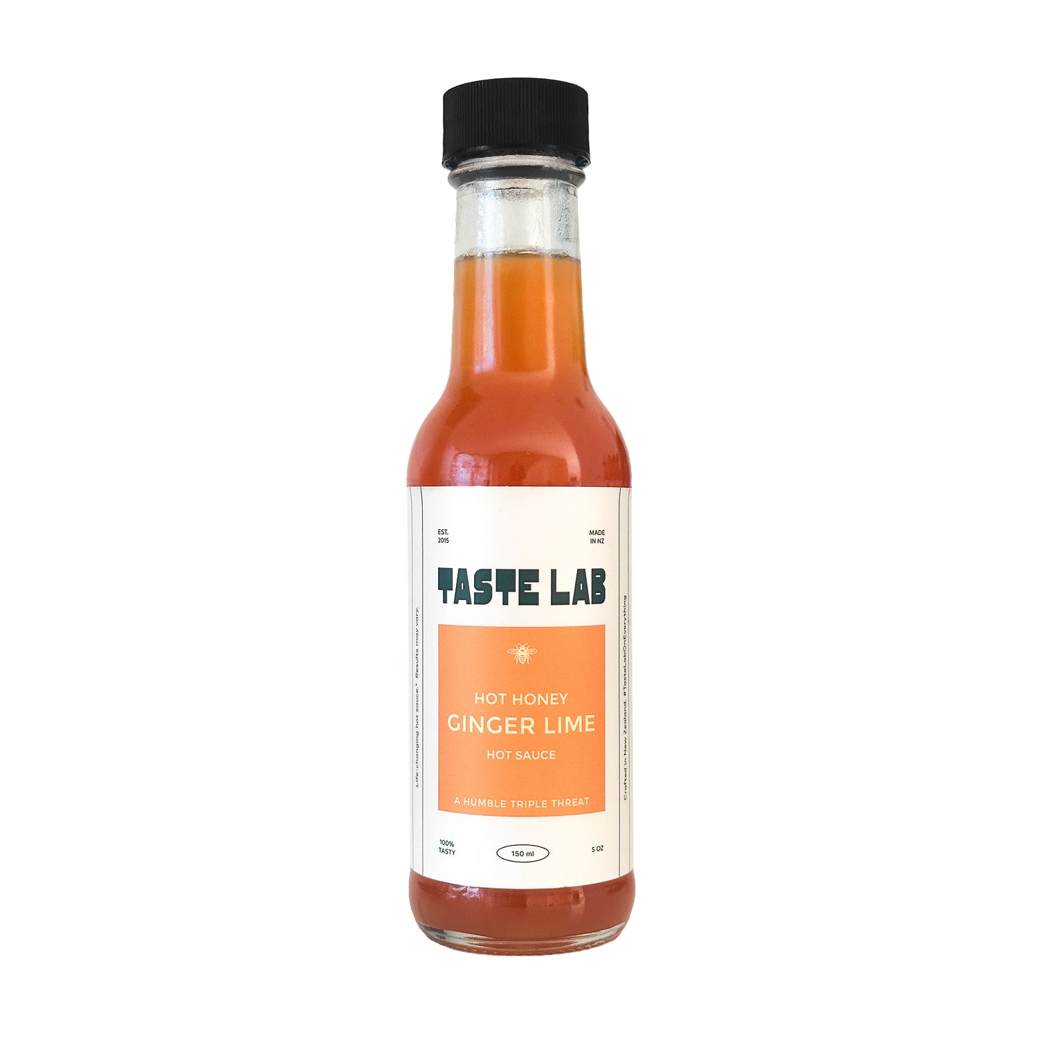 Bottle of Taste Lab Hot Honey Ginger Lime hot sauce on white.