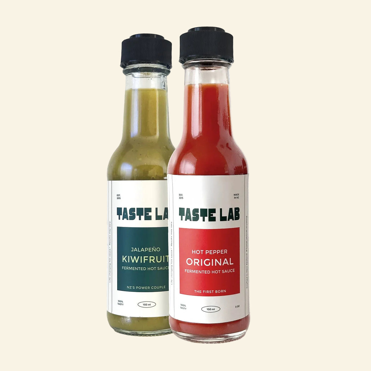 Two Taste Lab hot sauce bottles Jalapeño Kiwifruit (green) and Hot Pepper Original (red) standing side-by-side on a white background.